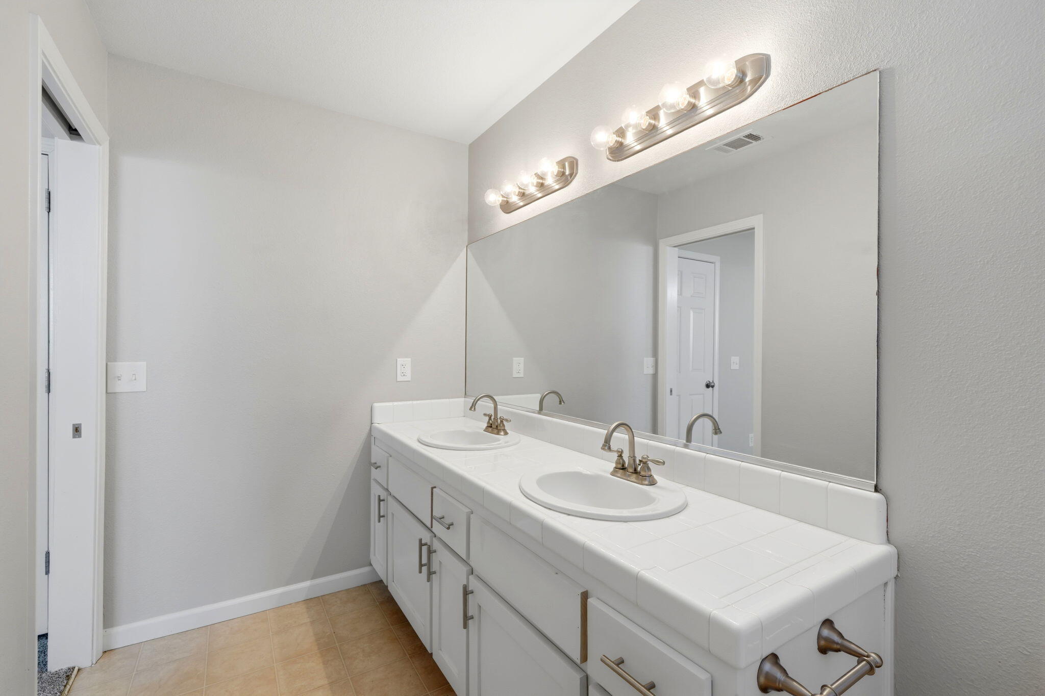 481 Katelyn Court Exeter, CA 93221 - Photo 20 of 33 a bathroom with a sink and a mirror