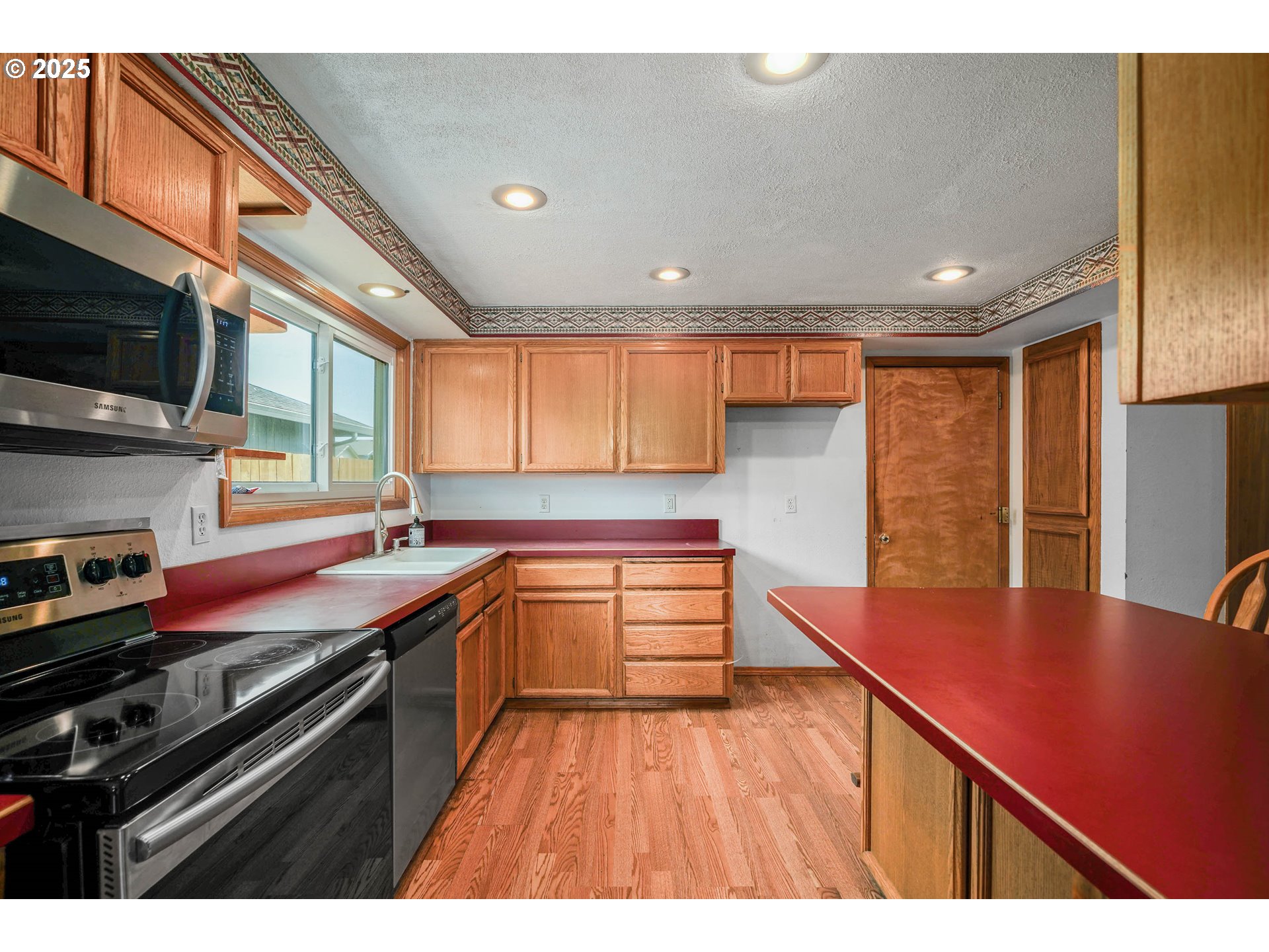 5259 Spring Leaf Court North Keizer, OR 97303 - Photo 11 of 30 a kitchen with stainless steel appliances granite countertop a sink stove and refrigerator
