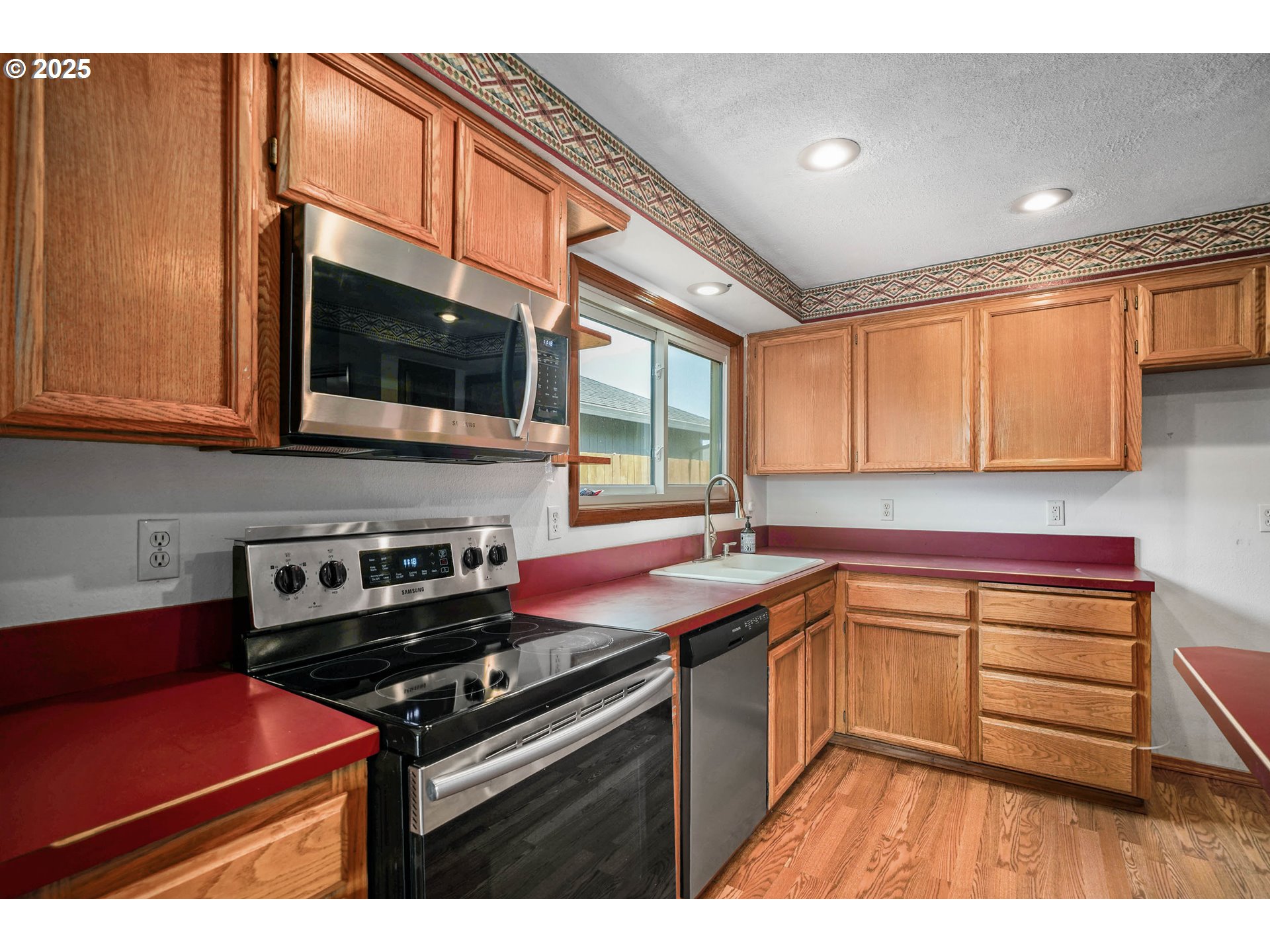 5259 Spring Leaf Court North Keizer, OR 97303 - Photo 12 of 30 a kitchen with stainless steel appliances granite countertop a sink stove and microwave