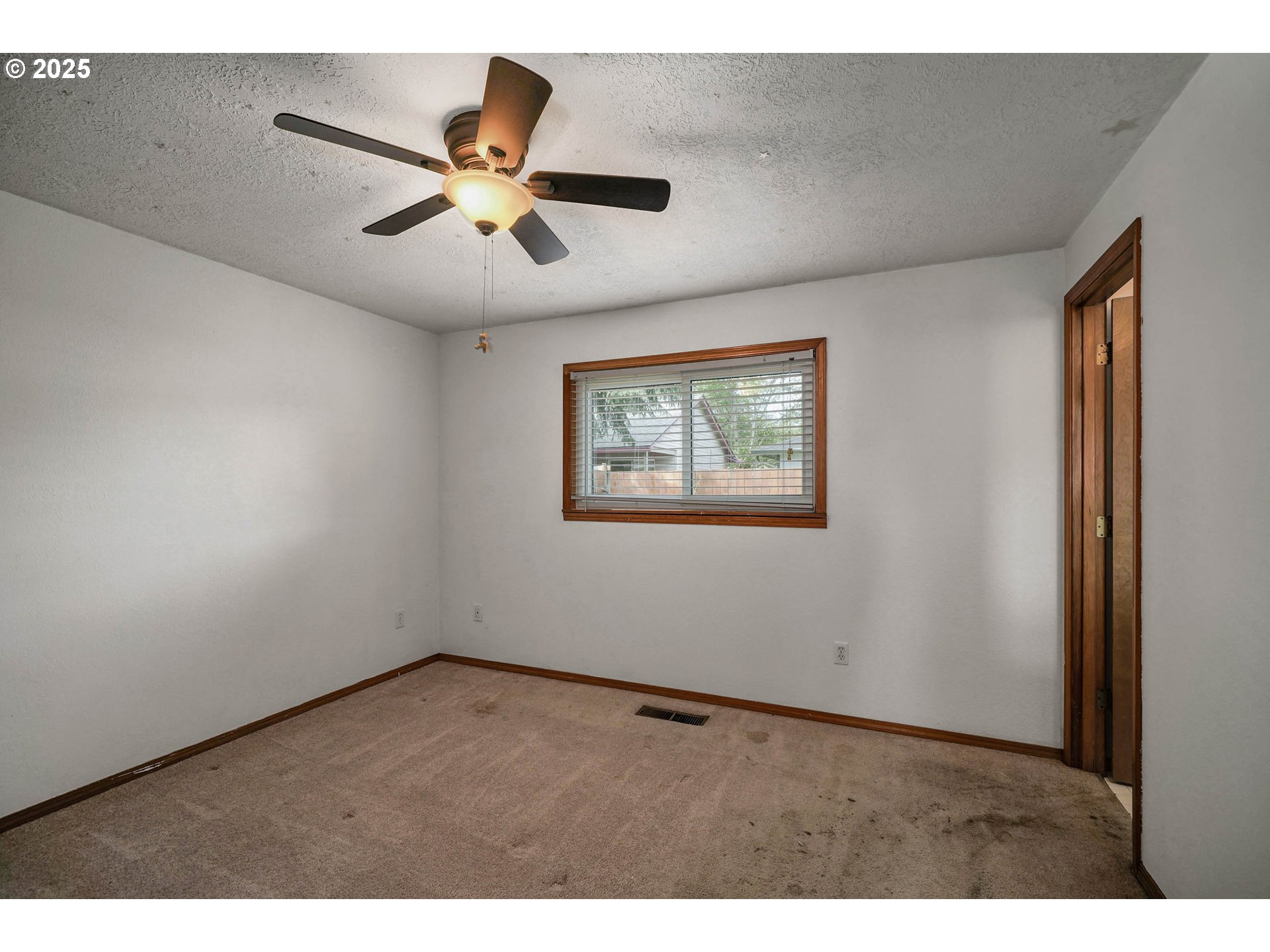 5259 Spring Leaf Court North Keizer, OR 97303 - Photo 21 of 30 a view of an empty room with wooden floor and a ceiling fan