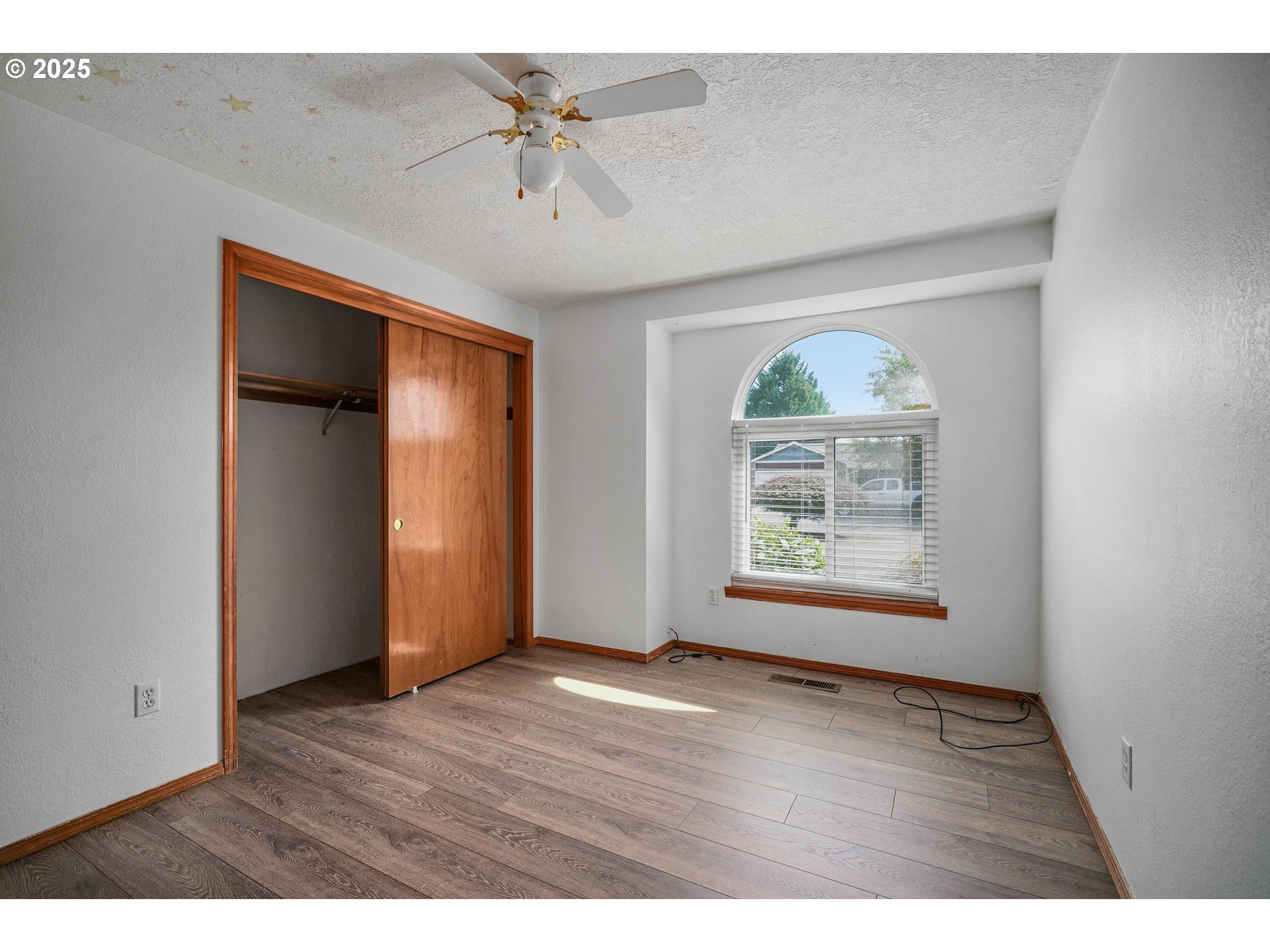 5259 Spring Leaf Court North Keizer, OR 97303 - Photo 23 of 30 a view of an empty room with wooden floor and a window