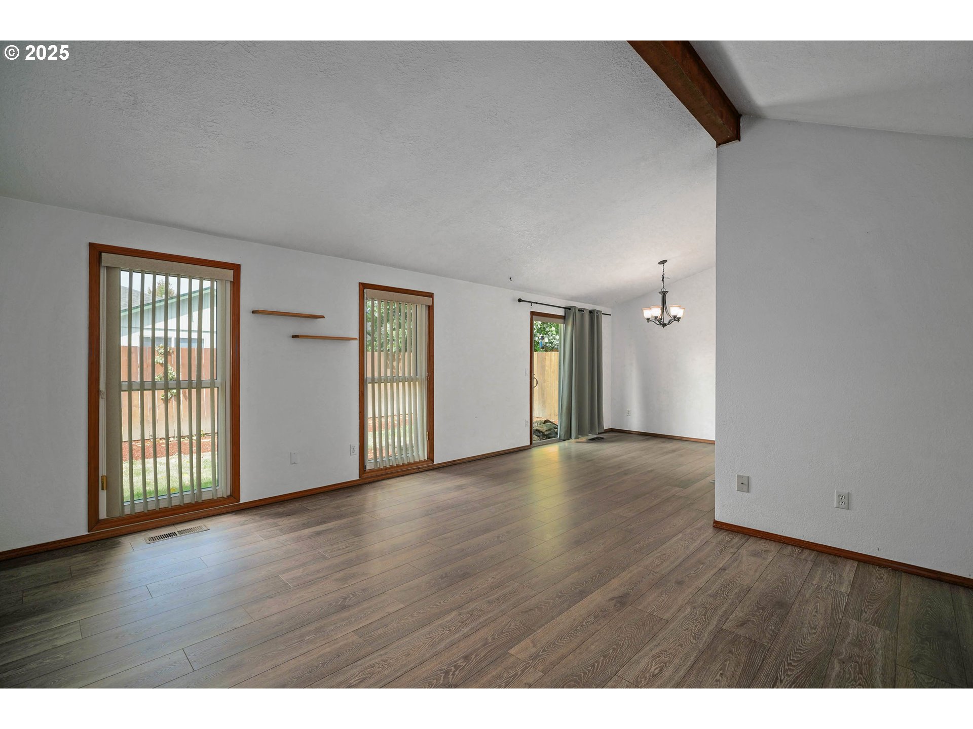 5259 Spring Leaf Court North Keizer, OR 97303 - Photo 5 of 30 a view of an empty room with wooden floor and windows