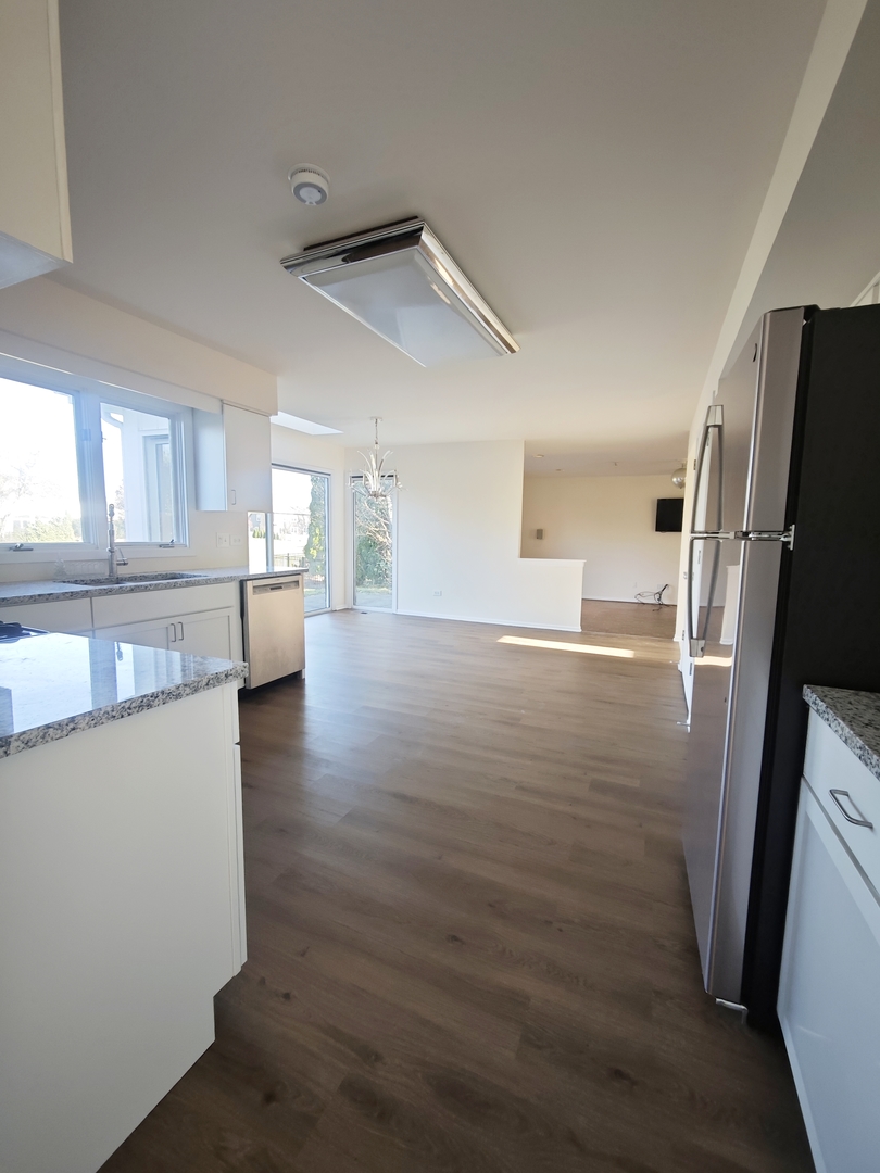 3820 Kiess Drive Glenview, IL 60026 - Photo 14 of 44 a view of a kitchen with wooden floor and electronic appliances