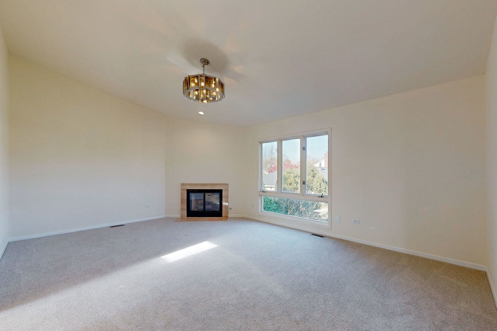 3820 Kiess Drive Glenview, IL 60026 - Photo 20 of 44 an empty room with a fireplace and window