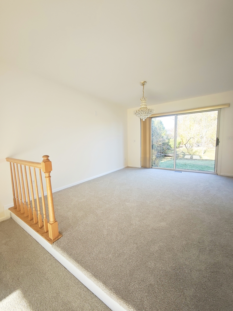 3820 Kiess Drive Glenview, IL 60026 - Photo 8 of 44 a view of a room with wooden floor and a large window