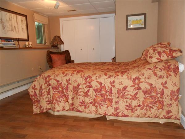 203 Hampton Road Sharon, MA 02067 - Photo 23 of 29 a bedroom with a bed and painting on the wall