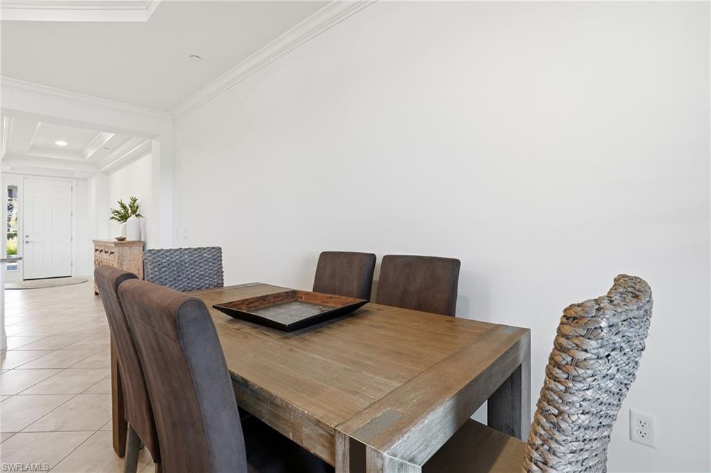 8773 Bellano Court, Unit 103 Naples, FL 34119 - Photo 15 of 47 Dining area featuring light tile patterned floors, ornamental molding, and recessed lighting