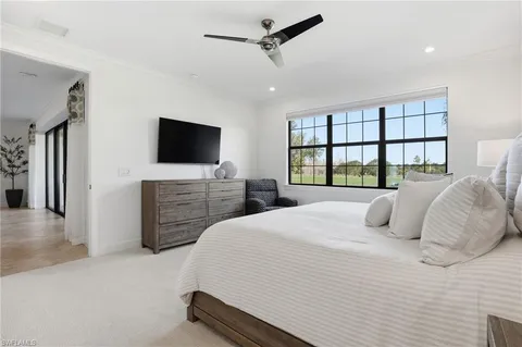 a large kitchen with stainless steel appliances lots of white cabinets