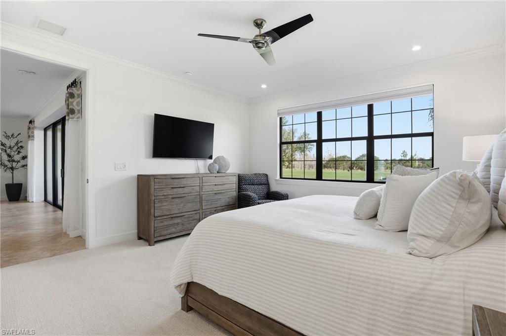 8773 Bellano Court, Unit 103 Naples, FL 34119 - Photo 23 of 47 Bedroom featuring carpet flooring, ornamental molding, a ceiling fan, and recessed lighting