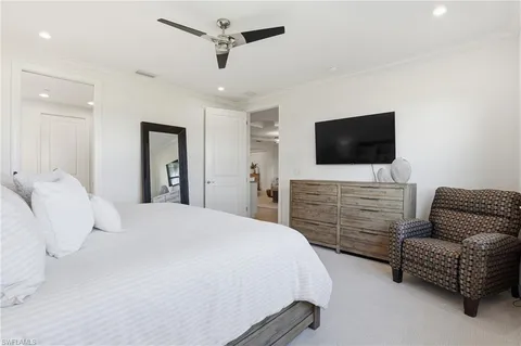 a bed sitting in a bedroom next to a window