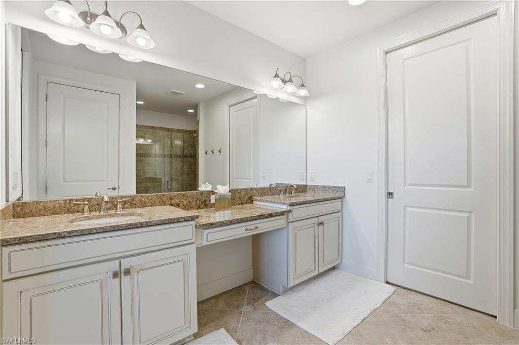 8773 Bellano Court, Unit 103 Naples, FL 34119 - Photo 25 of 47 Full bathroom with a shower stall, double vanity, recessed lighting, and light tile patterned floors