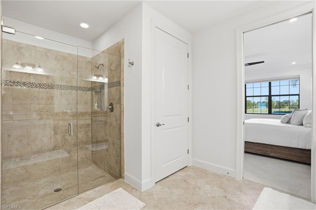 8773 Bellano Court, Unit 103 Naples, FL 34119 - Photo 26 of 47 Full bathroom featuring ensuite bathroom, recessed lighting, and a shower stall