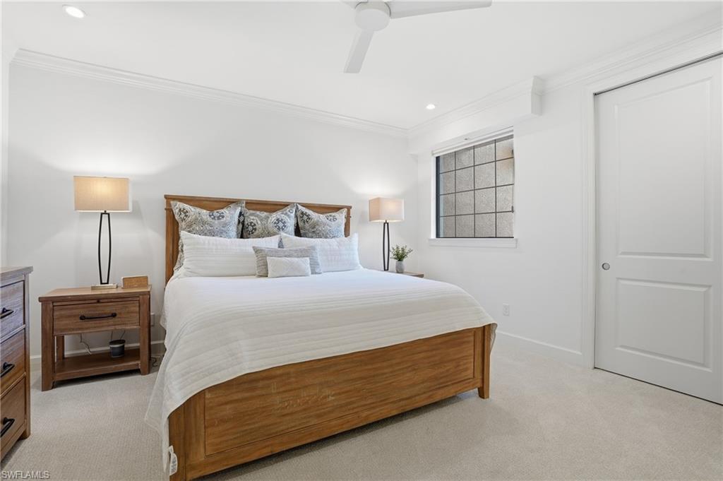 8773 Bellano Court, Unit 103 Naples, FL 34119 - Photo 27 of 47 Bedroom featuring a ceiling fan, light carpet, ornamental molding, and recessed lighting