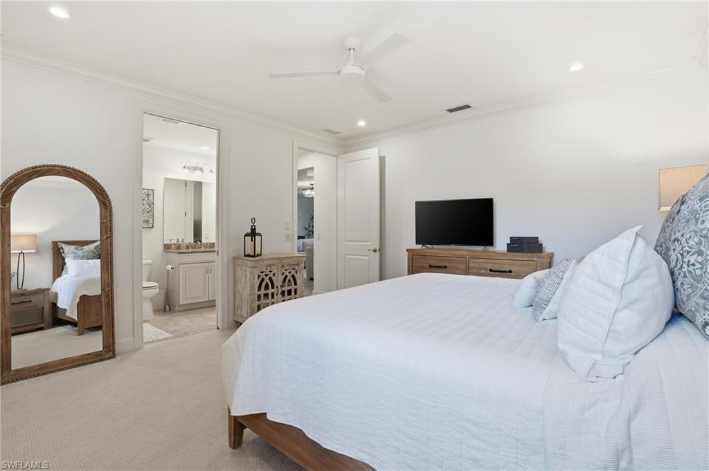 8773 Bellano Court, Unit 103 Naples, FL 34119 - Photo 28 of 47 Carpeted bedroom with recessed lighting, crown molding, ceiling fan, and ensuite bath