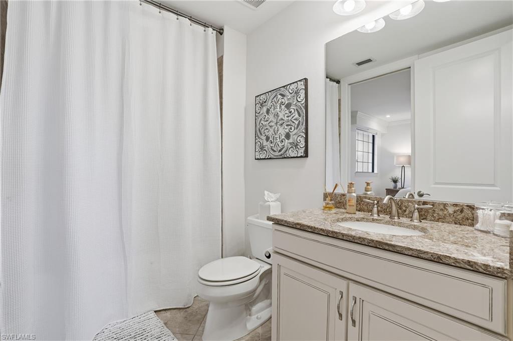 8773 Bellano Court, Unit 103 Naples, FL 34119 - Photo 29 of 47 Bathroom featuring vanity, a shower with shower curtain, and light tile patterned floors