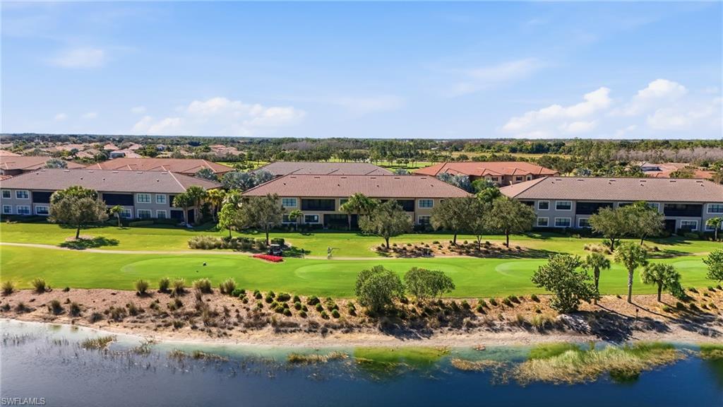 8773 Bellano Court, Unit 103 Naples, FL 34119 - Photo 35 of 47 Drone / aerial view of a nearby body of water and a local golf course