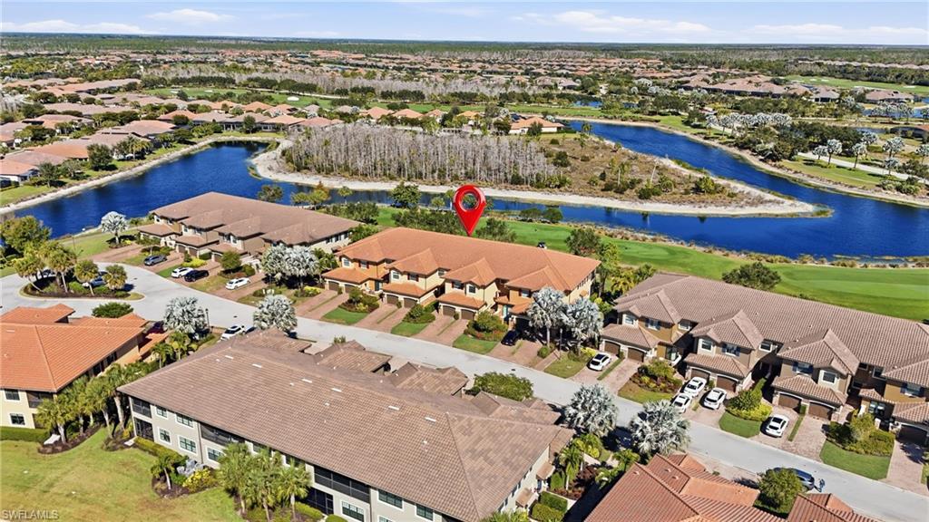 8773 Bellano Court, Unit 103 Naples, FL 34119 - Photo 5 of 47 Aerial view of residential area featuring a nearby body of water
