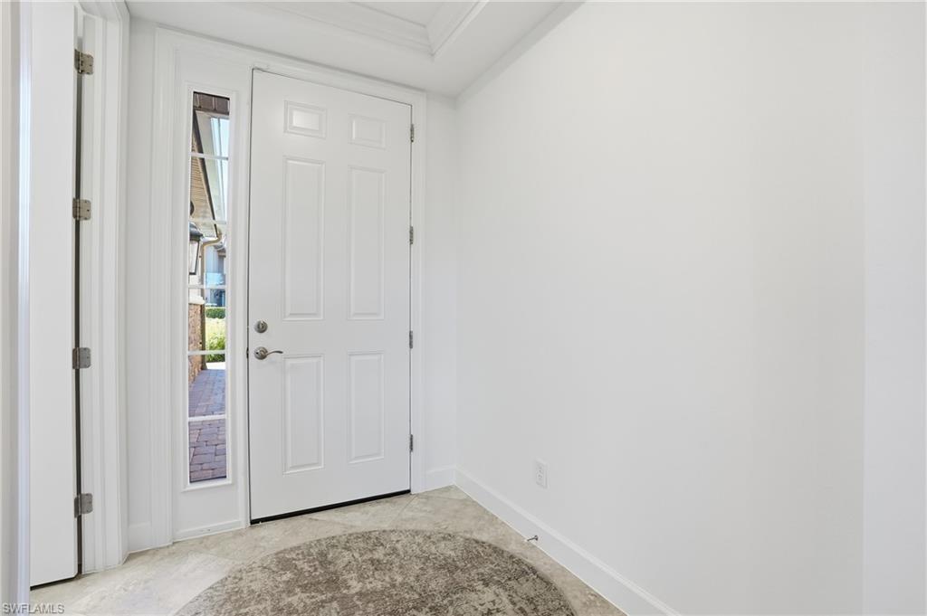 8773 Bellano Court, Unit 103 Naples, FL 34119 - Photo 6 of 47 Entryway with plenty of natural light and ornamental molding