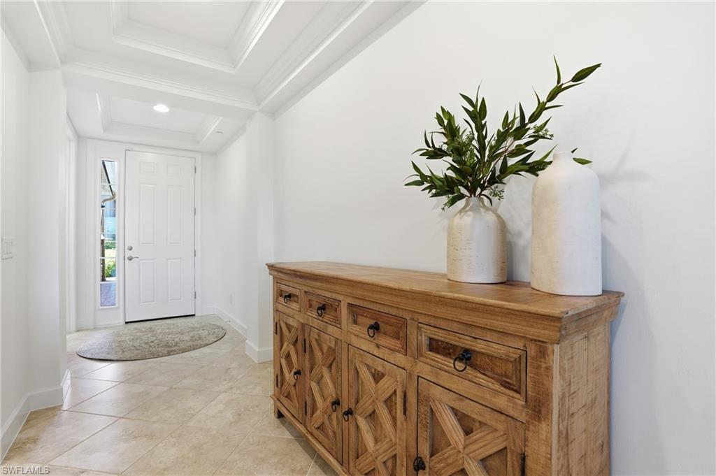 8773 Bellano Court, Unit 103 Naples, FL 34119 - Photo 7 of 47 Entryway with crown molding, light tile patterned flooring, and recessed lighting