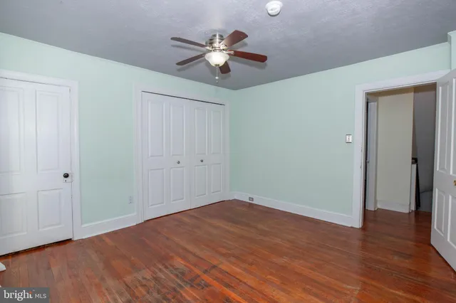a kitchen with granite countertop white cabinets and stainless steel appliances