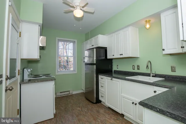 a kitchen with a stove and a refrigerator