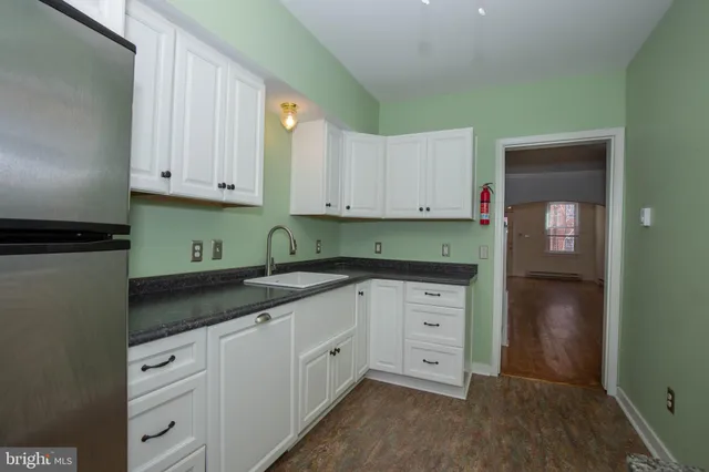a view of a kitchen with a sink and cabinets