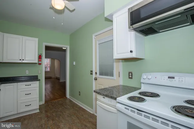 a kitchen with stainless steel appliances granite countertop a stove and a refrigerator