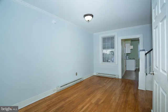 wooden floor in an empty room with a window