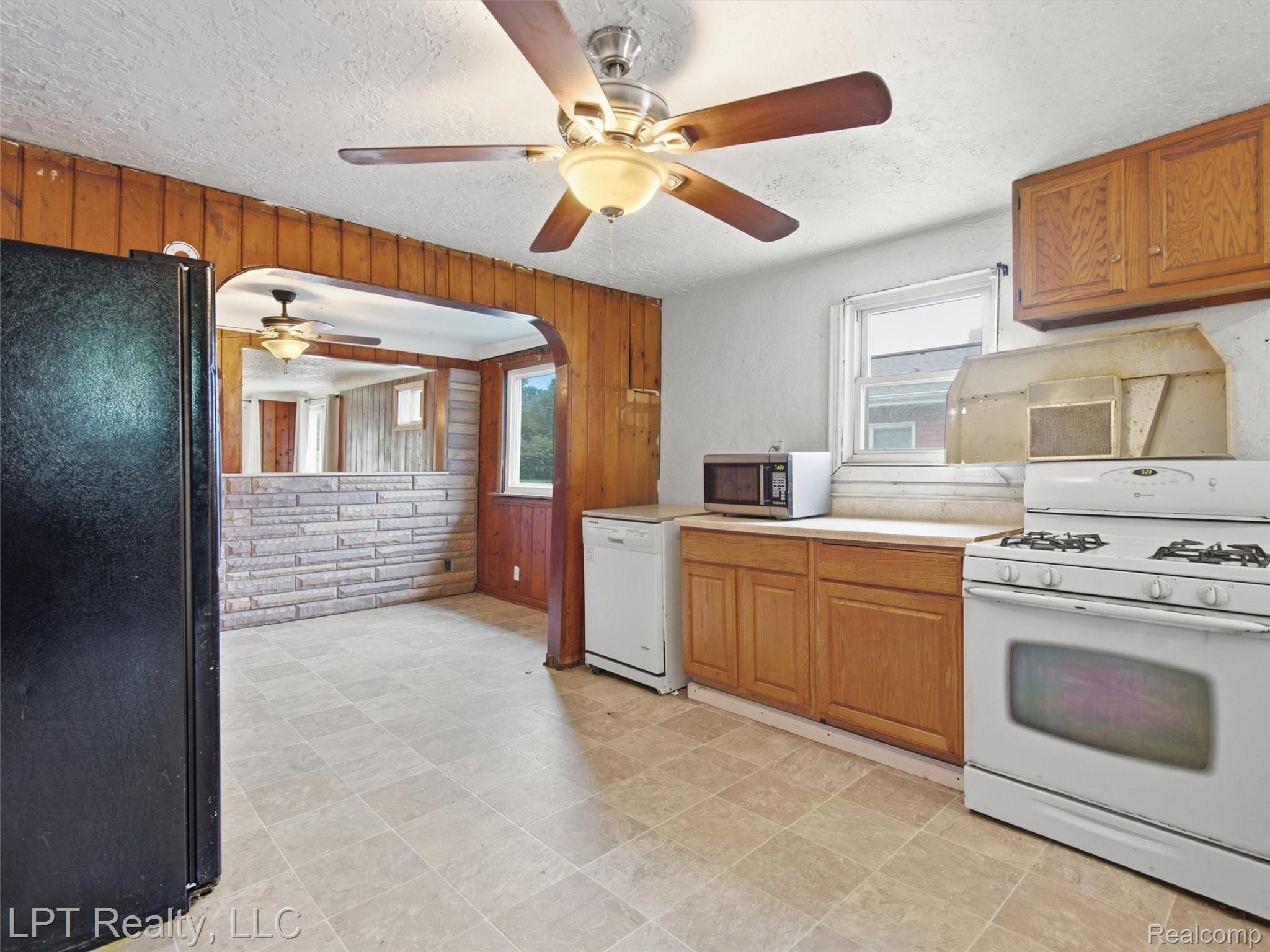 3385 North Genesee Road Flint, MI 48506 - Photo 14 of 24 Kitchen with tile flooring, wood cabinetry, and a ceiling fan