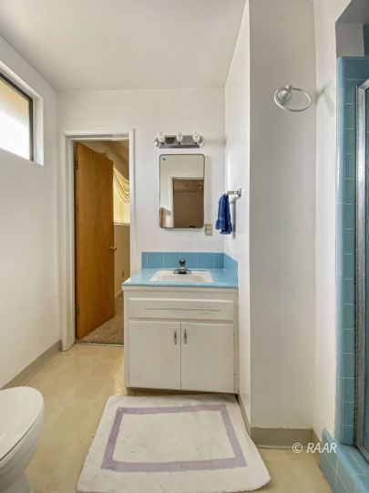 312 North Norma Street Ridgecrest, CA 93555 - Photo 15 of 18 a bathroom with a sink a toilet and mirror