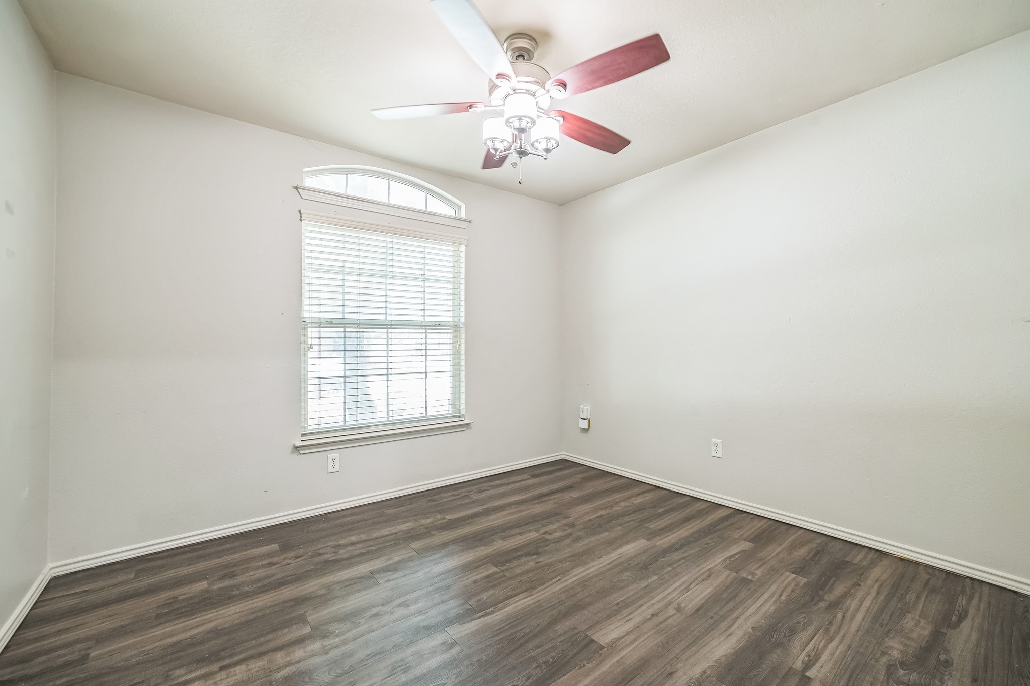 3630 Spring Canyon Trail Round Rock, TX 78681 - Photo 12 of 23 Empty room featuring a ceiling fan and dark wood-style flooring