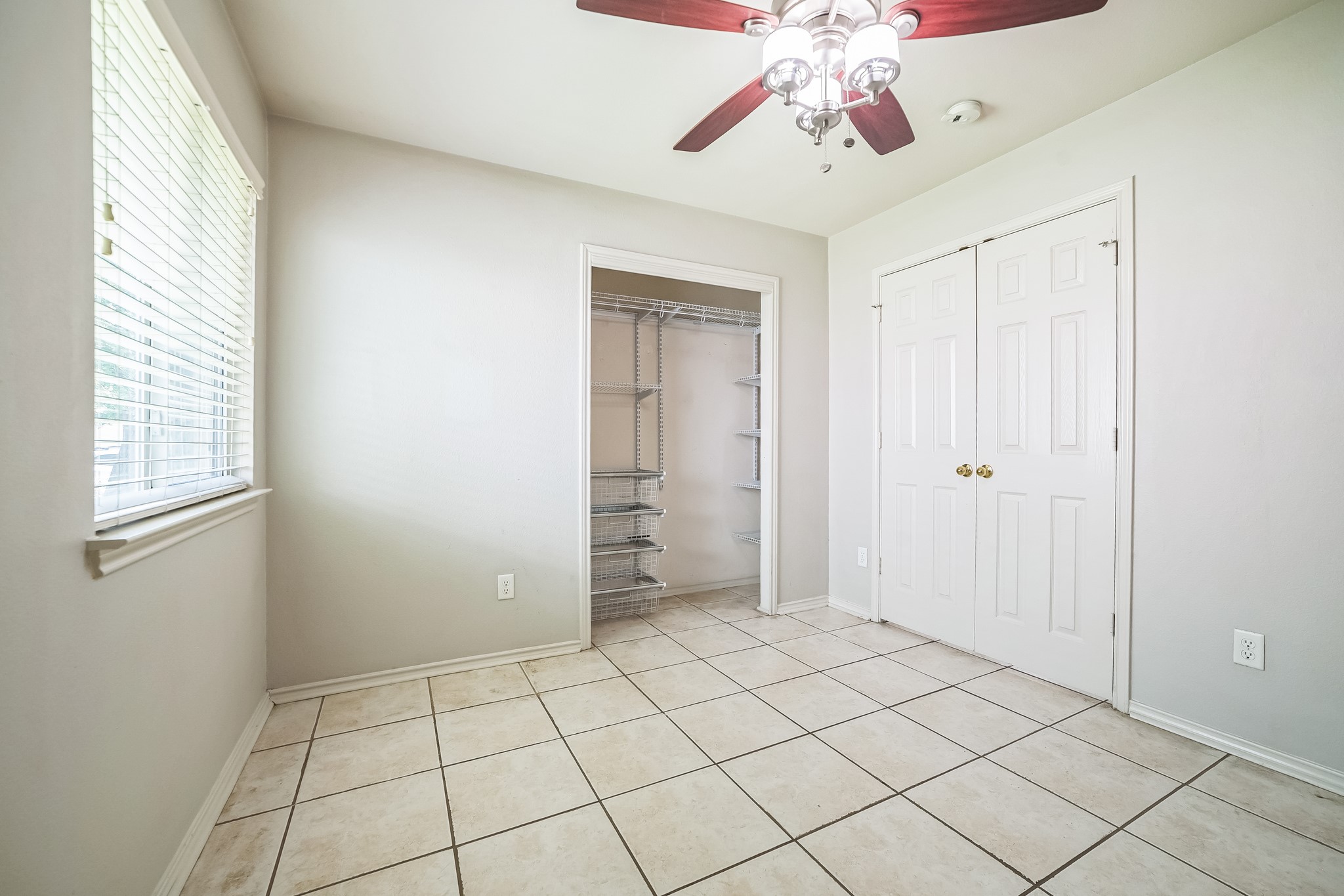 3630 Spring Canyon Trail Round Rock, TX 78681 - Photo 17 of 23 Unfurnished bedroom with a closet, a ceiling fan, and light tile patterned floors