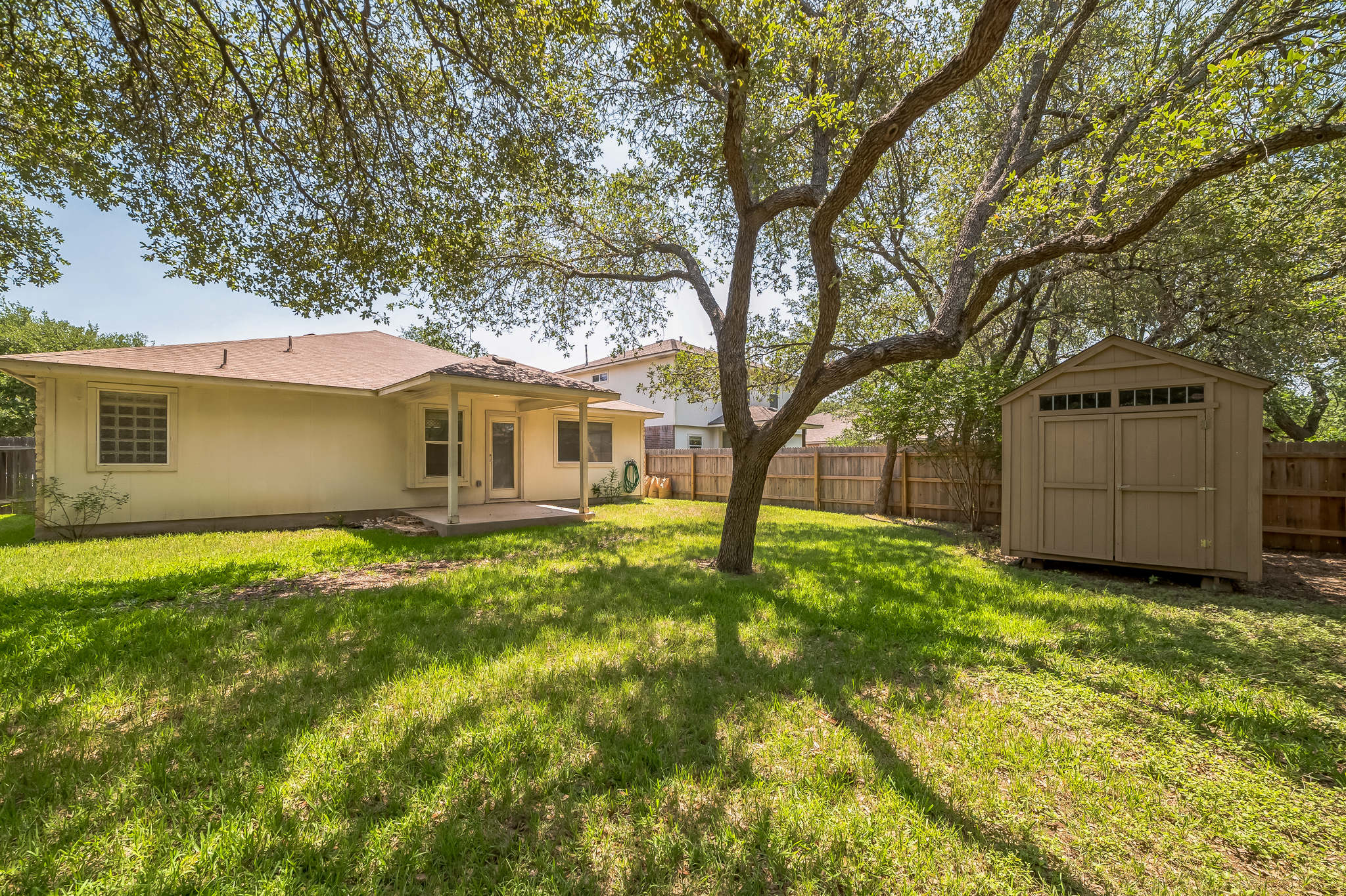 3630 Spring Canyon Trail Round Rock, TX 78681 - Photo 20 of 23 Fenced backyard with a patio and a storage shed