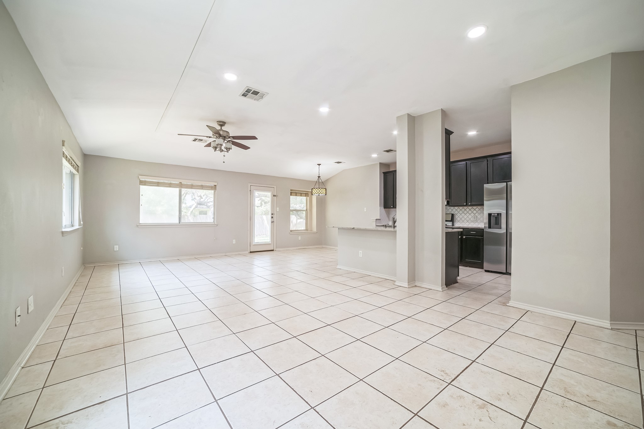 3630 Spring Canyon Trail Round Rock, TX 78681 - Photo 6 of 23 Unfurnished living room with ceiling fan, light tile patterned flooring, and recessed lighting