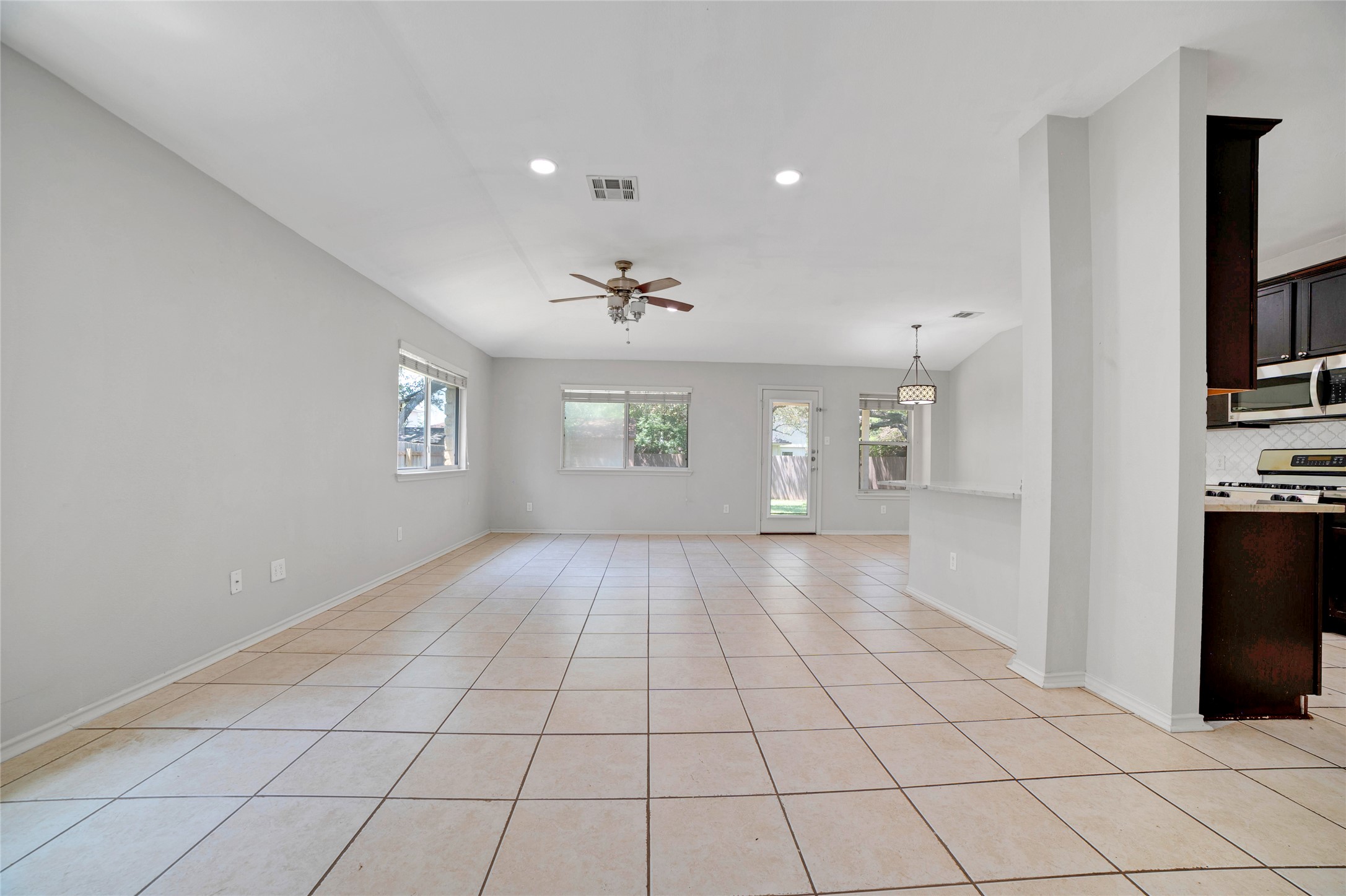 3630 Spring Canyon Trail Round Rock, TX 78681 - Photo 7 of 23 Unfurnished room featuring ceiling fan, recessed lighting, and light tile patterned floors