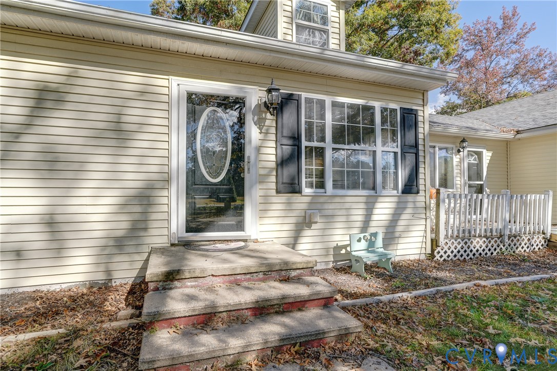 7759 Howerton Road Dunnsville, VA 22454 - Photo 1 of 1 a front view of a house with a garden