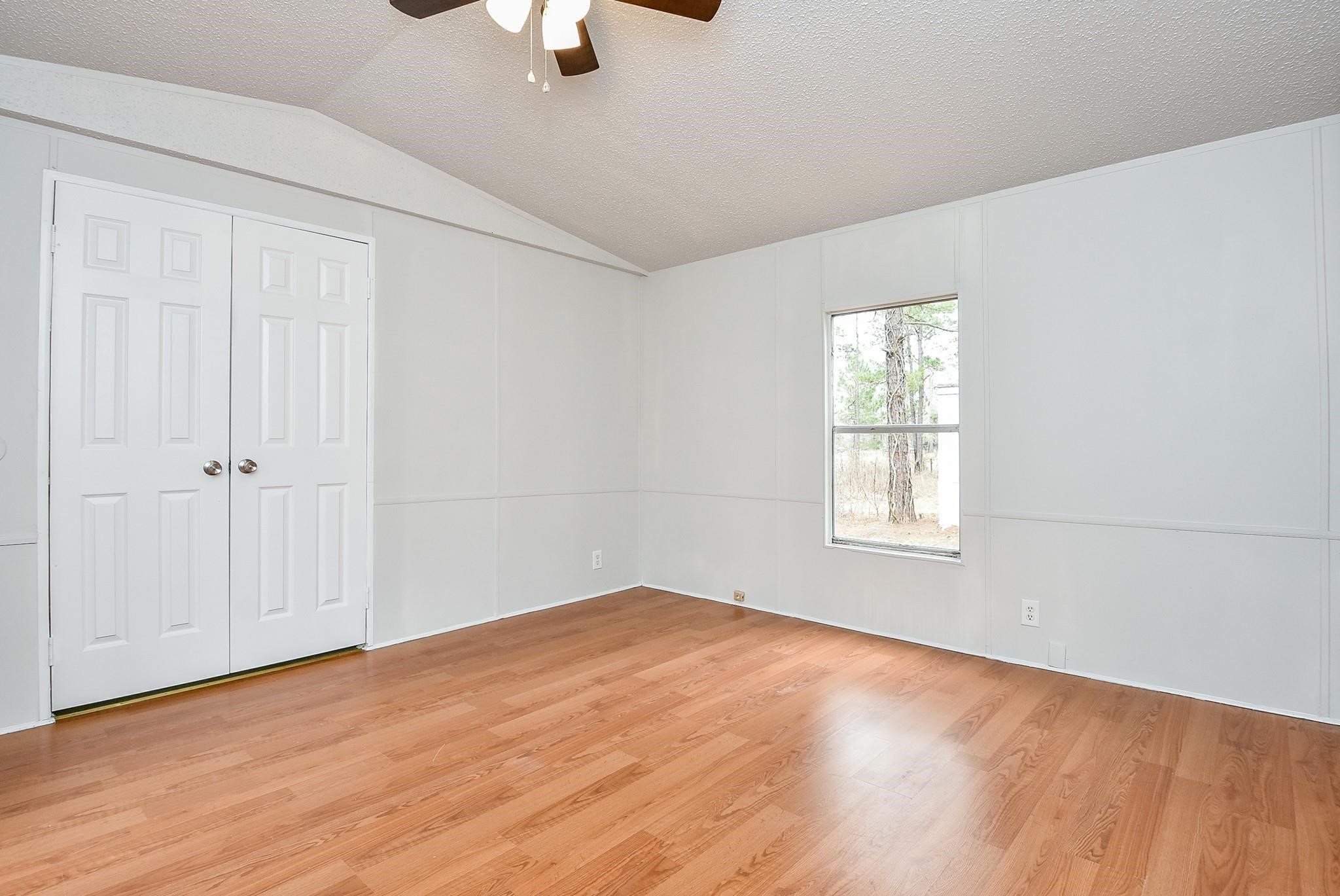 12842 Roy Harris Loop Conroe, TX 77306 - Photo 25 of 36 an empty room with windows and closet
