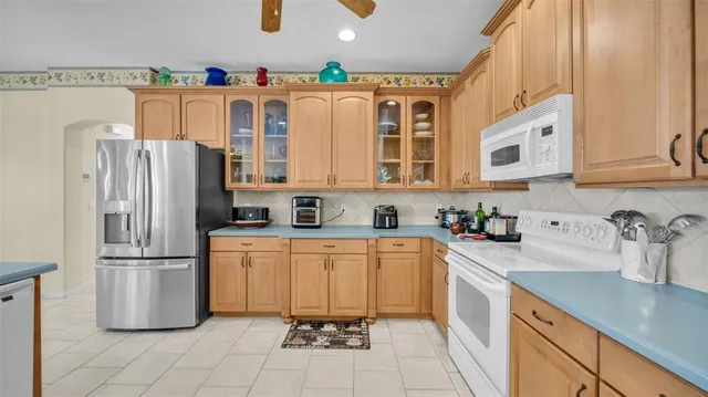 a kitchen with stainless steel appliances granite countertop a refrigerator sink and microwave