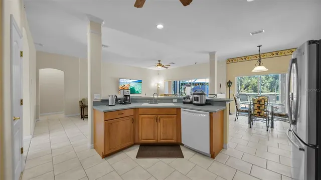 a kitchen with a sink and chairs