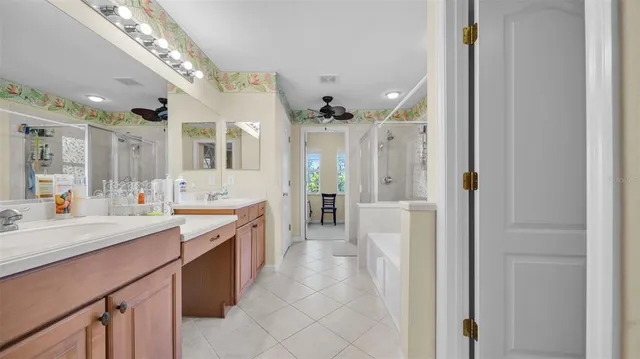 a large bathroom with a large mirror vanity and shower