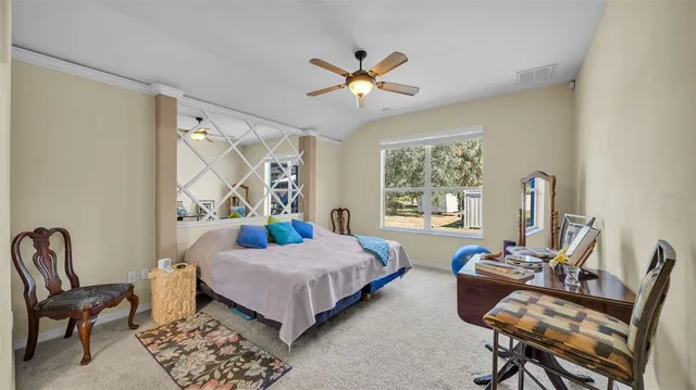 a bedroom with a bed chair and window