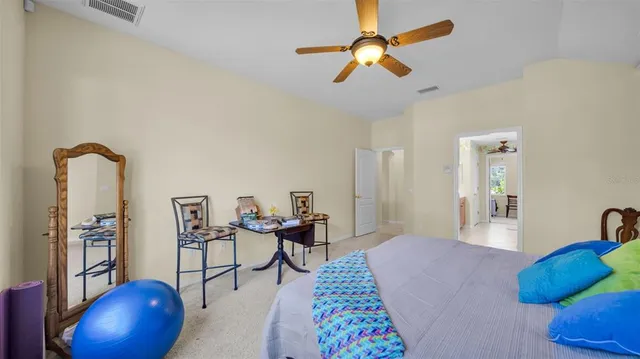 a bedroom with furniture and a chandelier