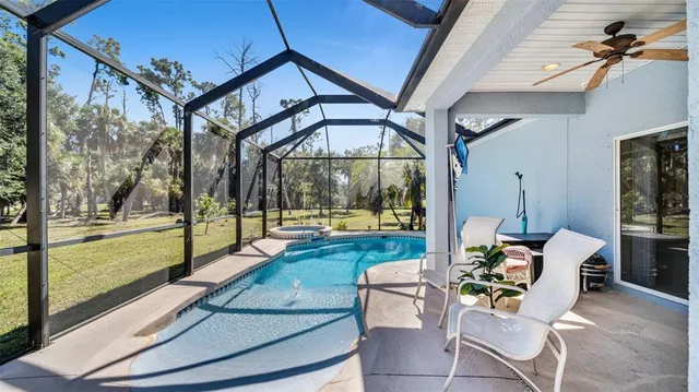 a patio with yard glass top table and sofas