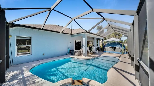 a view of a house with backyard sitting area and furniture