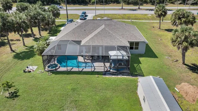 a view of a house with a yard and sitting area