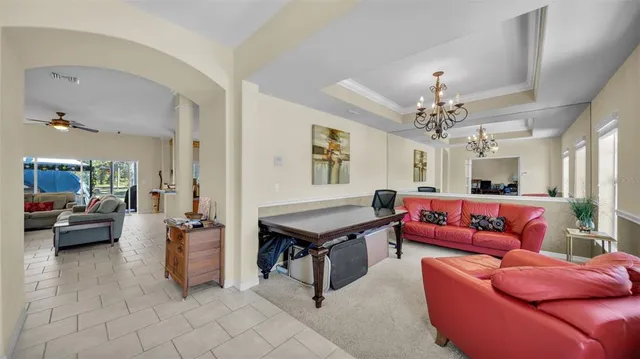 a living room with furniture and a chandelier