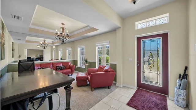 a living room with furniture and a chandelier
