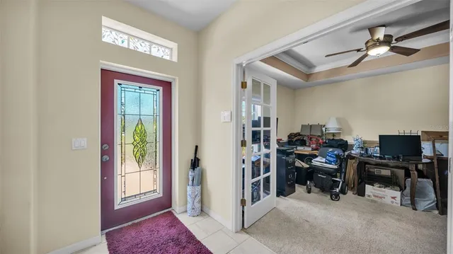 a view of a workspace with furniture and a window