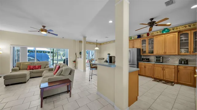 a living room with furniture and a kitchen