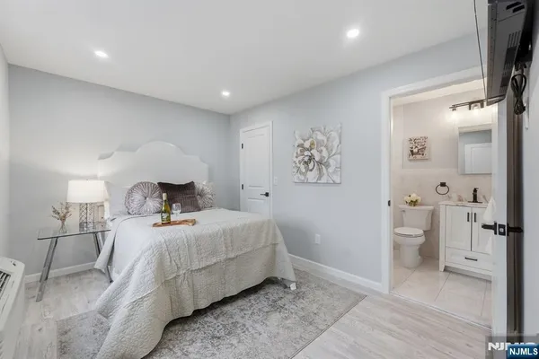 a bedroom with a bed and a view of bathroom